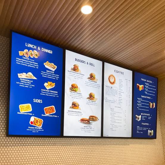 LED Digital Standee Video Display Signage for Branding, Advertising | Digital Advertising Display Screen | Led Video Standee 43" Wall Mounted Menu board with lunch, dinner, burger, and coffee options on a wall.