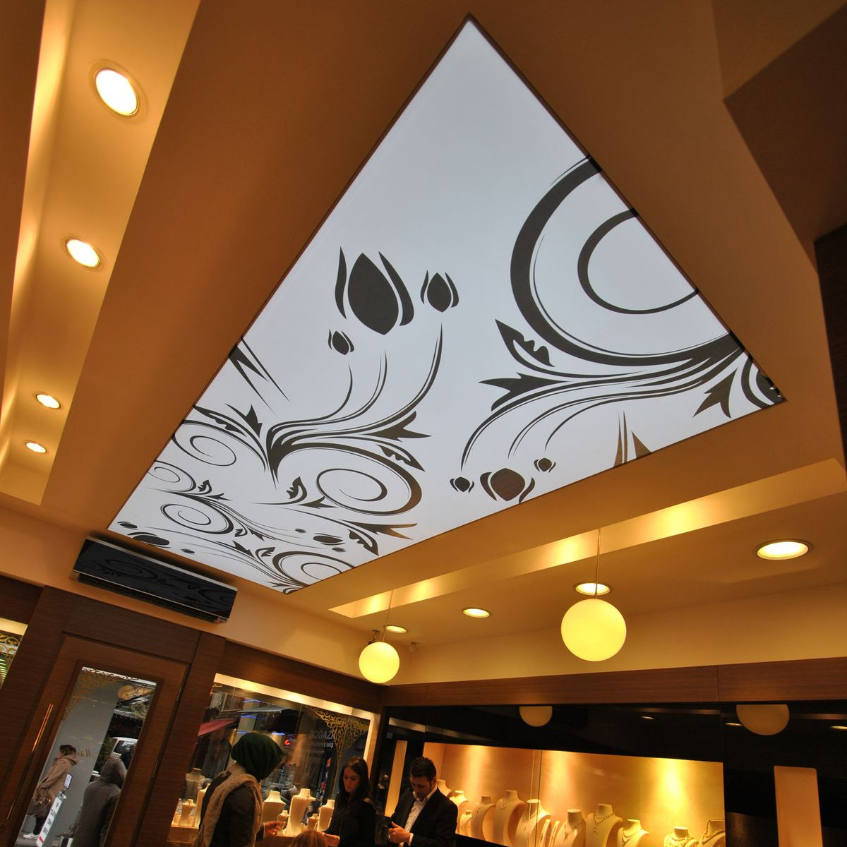 Backlit fabric ceiling panel featuring custom black and white ornamental artwork