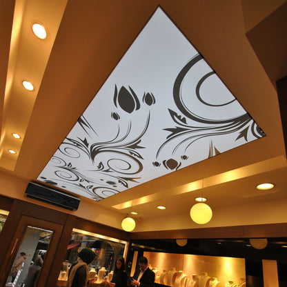 Backlit fabric ceiling panel featuring custom black and white ornamental artwork