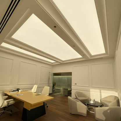 Custom backlit fabric ceiling light boxes creating soft ambient lighting in a premium office interior