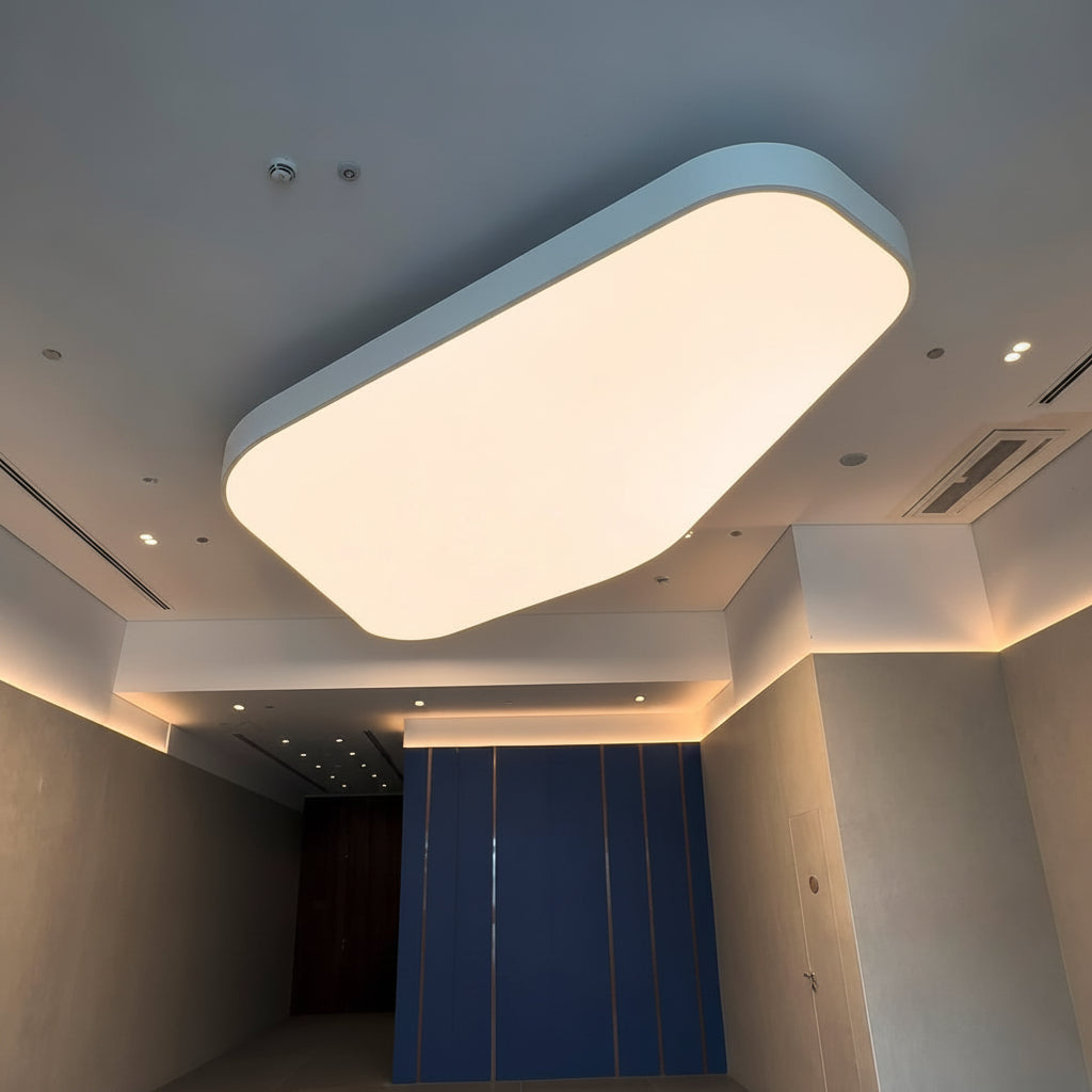 Curved LED fabric ceiling light panel with soft white illumination in a contemporary commercial space