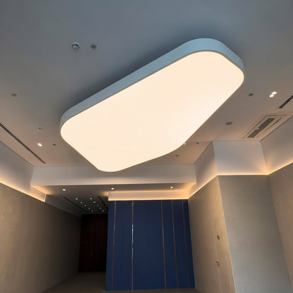 Curved LED fabric ceiling light panel with soft white illumination in a contemporary commercial space