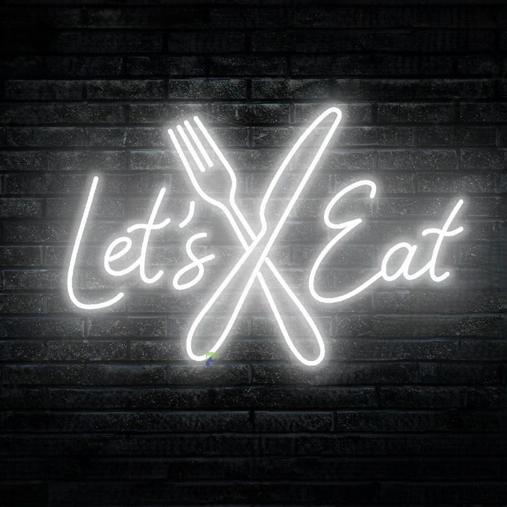 Lets Eat Knife Spoon Neon Sign | Custom Neon Sign | Neon for Restaurants Neon sign with 'Let's Eat' and crossed utensils on a brick wall background