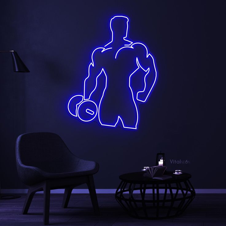 Men Hand Dumble Neon Sign | Custom Neon Sign | Neon for Gym Decoration Sign Neon sign of a muscular figure lifting weights in a dark room with a chair and small table.