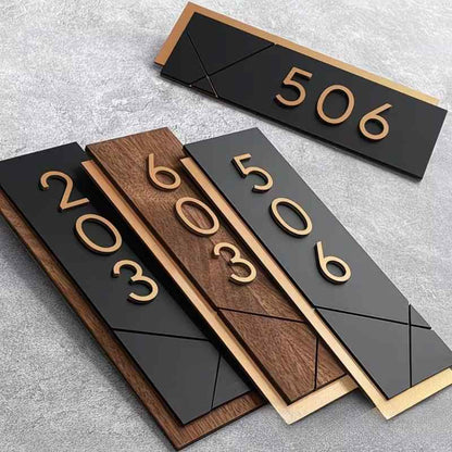 Contemporary custom house number sign featuring gold numerals on black and wood-effect panels, geometric detailing and illuminated wall-mounted designs.