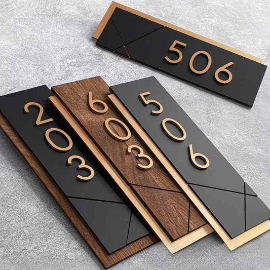 Contemporary custom house number sign featuring gold numerals on black and wood-effect panels, geometric detailing and illuminated wall-mounted designs.