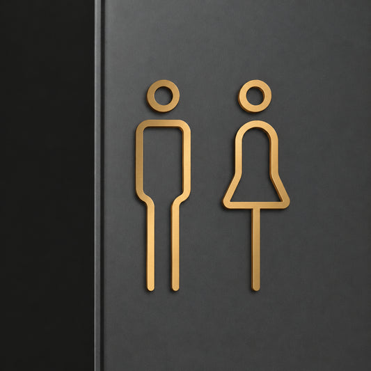Premium gold toilet signage for men and women displayed on wooden, beige stone and white marble walls in contemporary commercial interiors