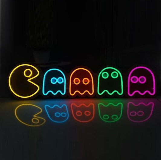 Pacmen Neon Sign | Custom Neon Sign | Neon for Living Room Decor Neon signs of Pac-Man ghosts on a reflective surface with a dark background