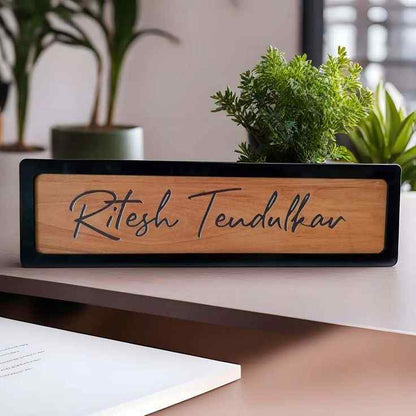 Custom wooden entrance nameplate with black border displayed on a modern home exterior wall.