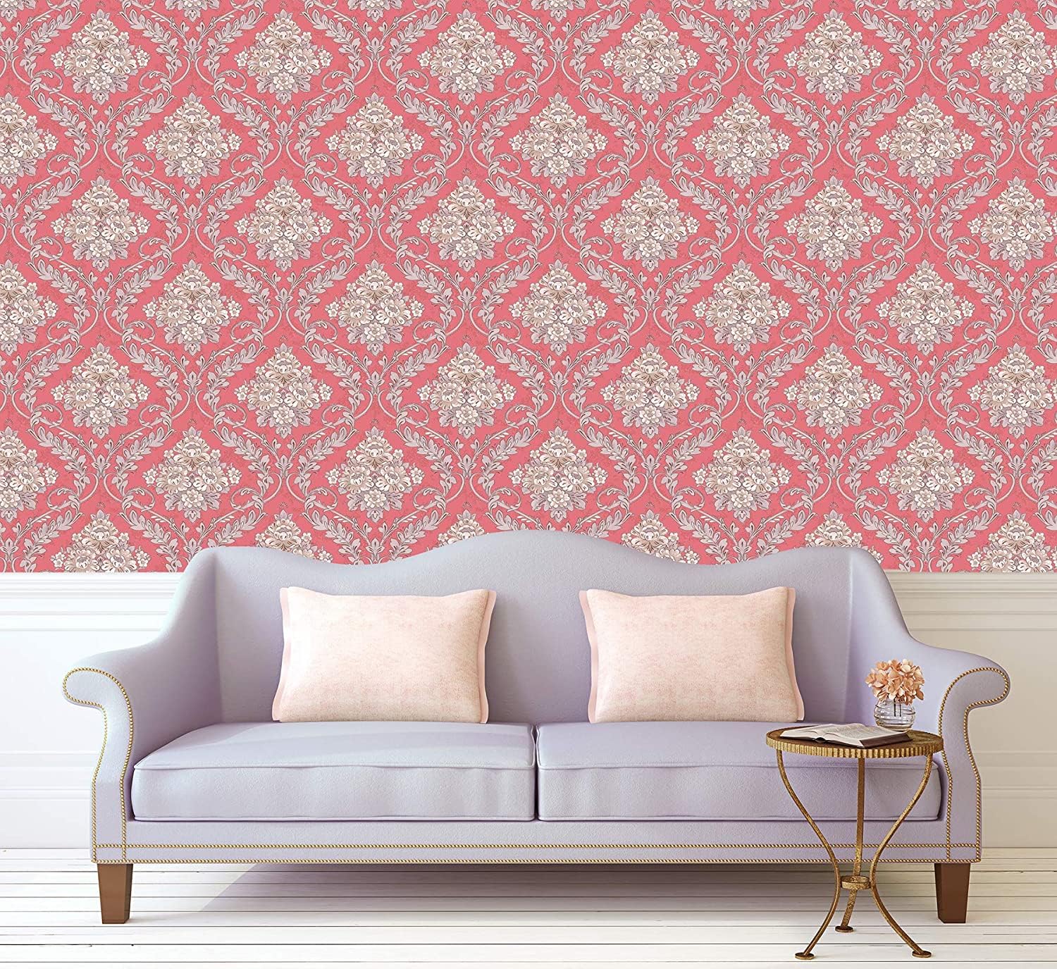 Decorative wallpaper with pink and white pattern behind a gray sofa with beige pillows.
