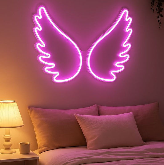 Pink Wings Neon Sign | Custom Neon Sign | Neon for Living Room, Restaurants Neon pink angel wings on a wall above a bed with pink bedding.