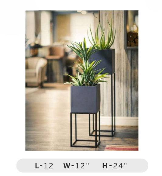 Planters Pots for Decors, Giftings | FRP Pots and Planets for Office Decors Two dark gray planters with green plants inside, placed on a wooden floor.