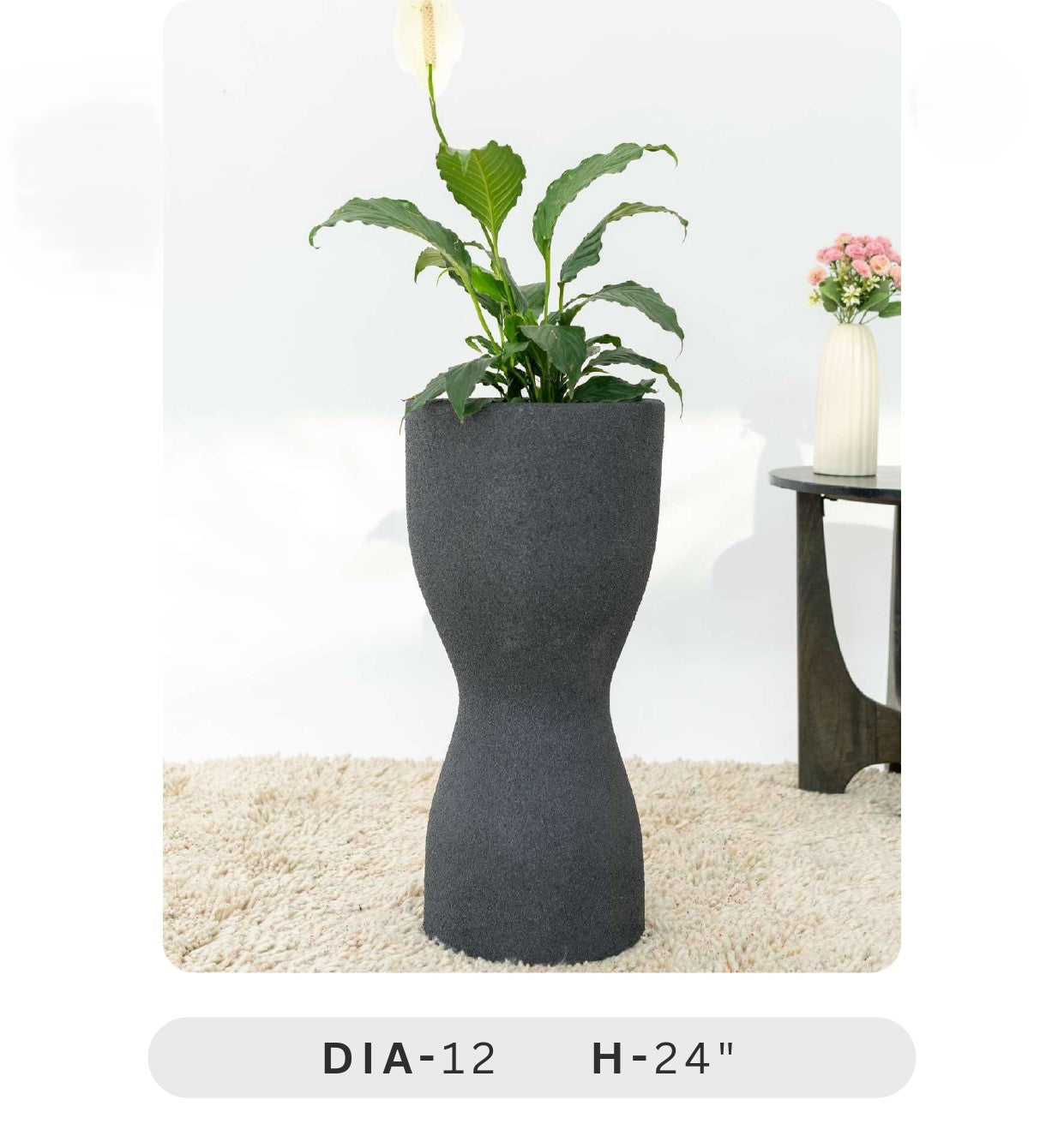 Planters Pots for Decors, Giftings | FRP Pots and Planets for Office Decors Gray hourglass-shaped planter with a plant on a white background