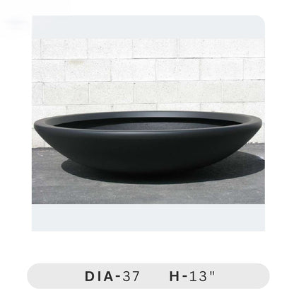 Planters Pots for Decors, Giftings | FRP Pots and Planets for Office Decors Black round planter on a light gray surface with a white tiled wall background