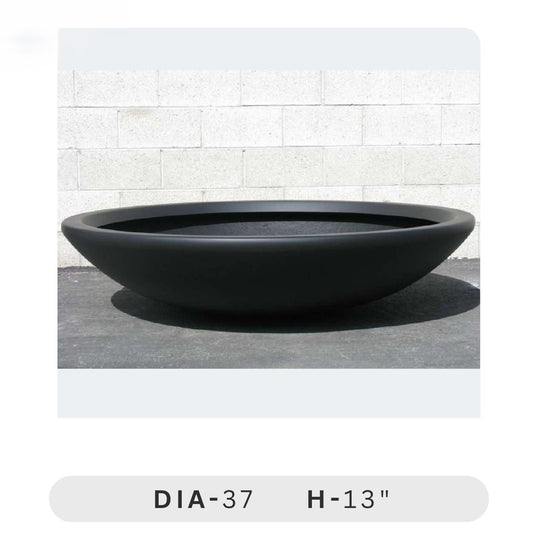 Planters Pots for Decors, Giftings | FRP Pots and Planets for Office Decors Black round planter on a light gray surface with a white tiled wall background