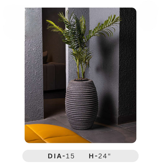 Planters Pots for Decors, Giftings | FRP Pots and Planets for Office Decors Decorative plant pot with a plant inside, placed against a textured wall.