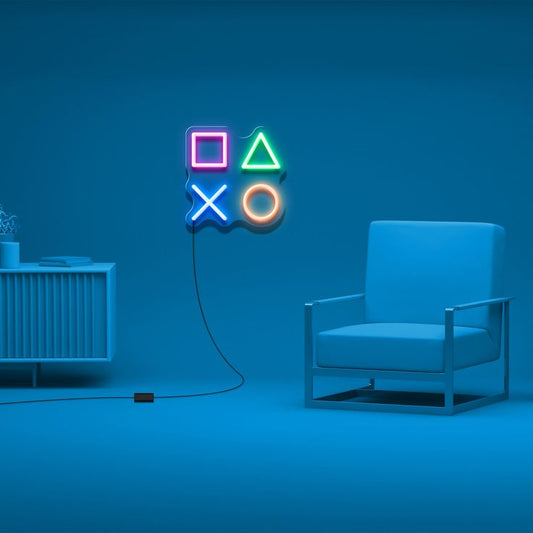 PlayStation Button Neon Sign  – Custom Neon Sign for Game Room 18 By 18 Inches Neon sign with gaming symbols on a blue wall above a modern chair.