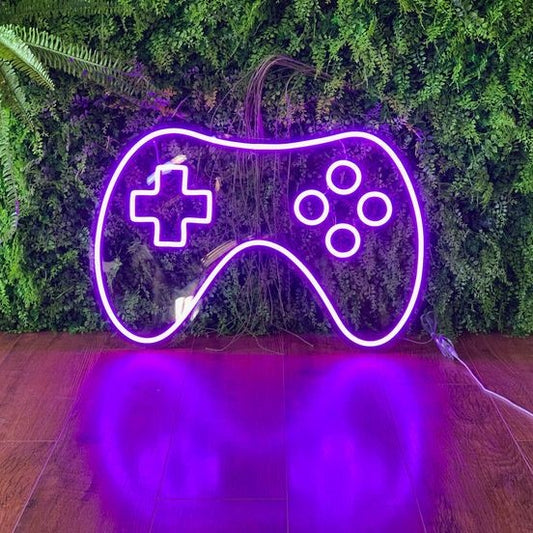 PlayStation Neon Remote – Custom Neon Sign for Game Room 20 By 15 inches  Neon purple gaming controller shape against a green leafy background