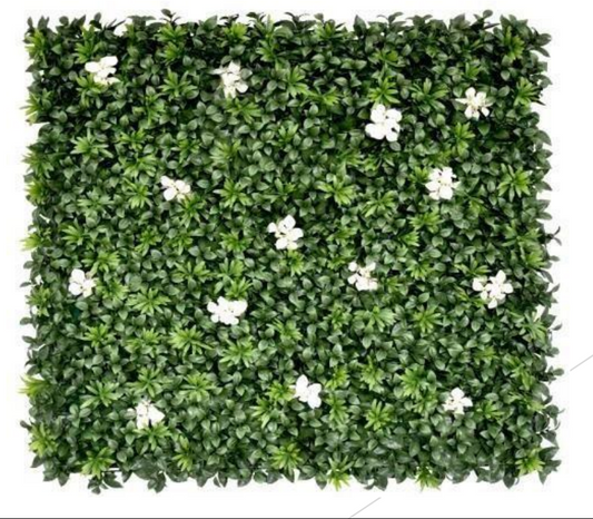 Decorative artificial green hedge wall featuring realistic foliage and white floral accents