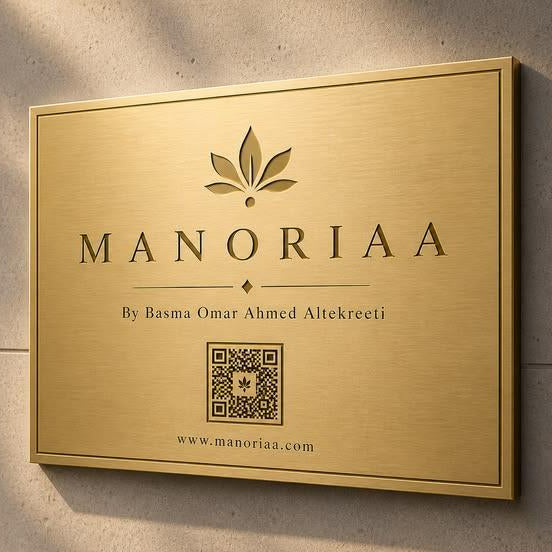 Luxury brushed gold wall signage with personalized business branding, botanical emblem, website address, and QR code displayed on modern stone and wooden walls.