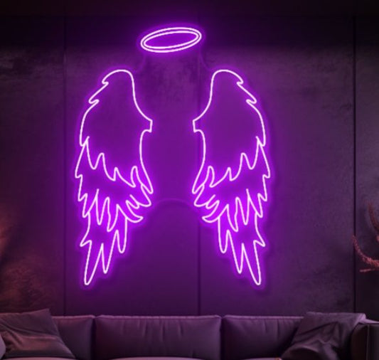 Purple Wings Neon Sign | Custom Neon Sign | Neon for Living Room Neon purple angel wings with a halo on a dark wall above a sofa.