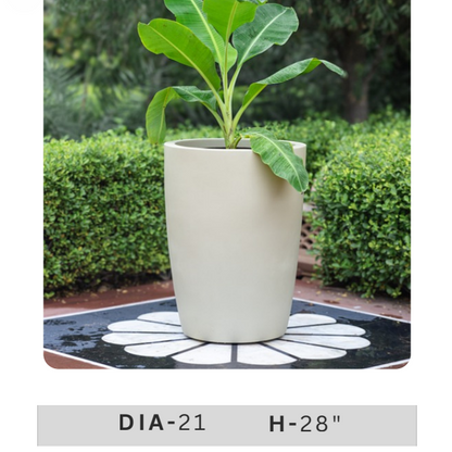 Beige cylindrical decorative planter with green indoor plant for contemporary home and office interiors