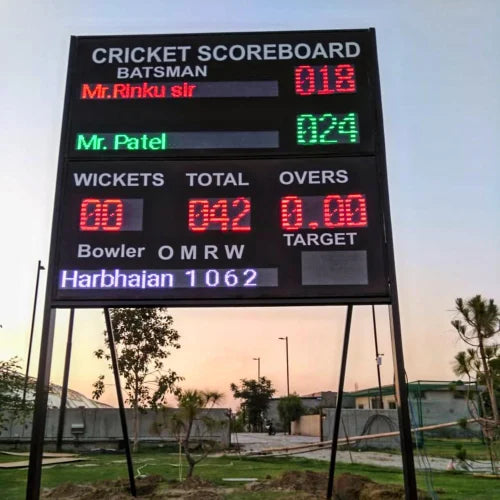 The Seven Colours LED Sports Scoreboard | LED Running Sports Scoreboard for Cricket | Led Cricket Scoreboard for Football, Volleyball, Hockey, Basketball, Badminton, Tennis Cricket scoreboard displaying scores and details on a sports field.