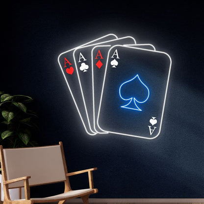 Trams Card Neon Sign – Custom Neon Sign for Living Room 20 By 20 Inches Neon lights shaped like playing cards on a dark wall with a chair in the foreground.