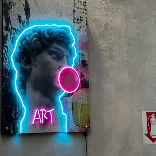 UV David Blowing Gum Neon Sign | Custom Neon Sign | Neon for Detailing Studio Neon sign of a classical statue with 'ART' text on a textured wall.