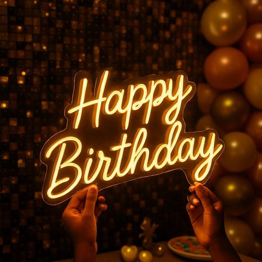 Warm White Happy Birthday Neon Sign | Custom Neon Sign | Neon for Birthday Decor Neon 'Happy Birthday' sign held by hands with balloons in the background