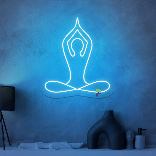 Yoga Neon Sign | Custom Neon Sign | Neon for Living Room Neon sign of a yoga pose on a textured blue wall with minimal decor.