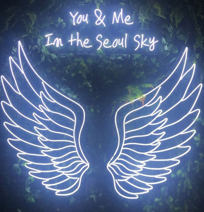 You and Me Wings Neon Sign | Custom Neon Sign | Neon for Restaurants, Banquet Neon sign with wings and text 'You & Me In the Seoul Sky' against a dark background