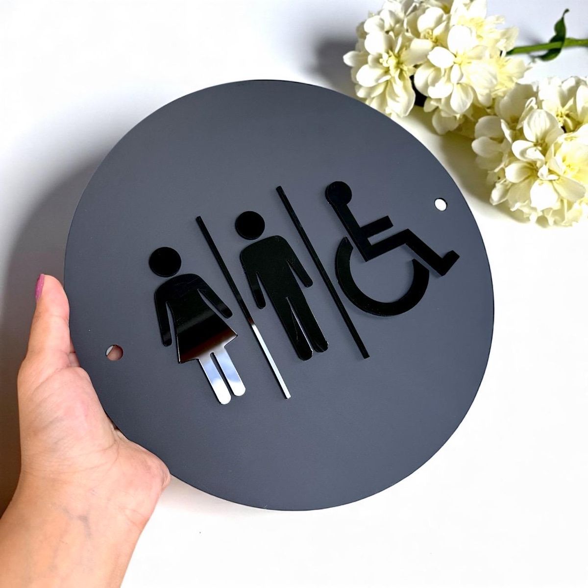 Accessible restroom sign with male female and wheelchair symbols
