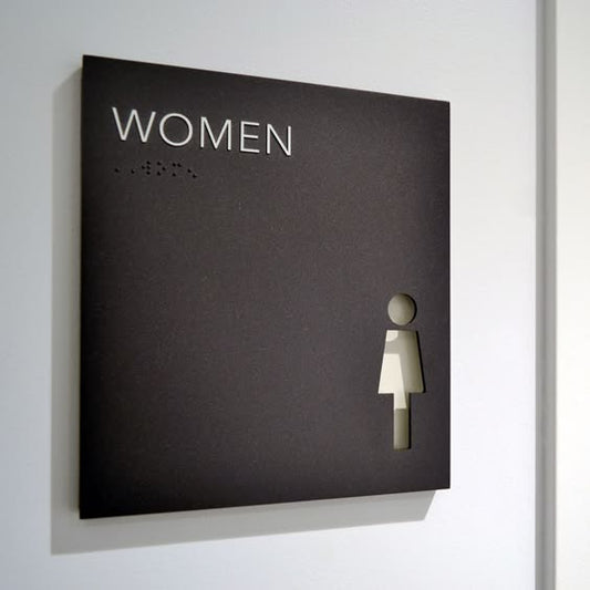 Accessible women restroom sign with braille and female washroom symbol for ADA bathroom signage.