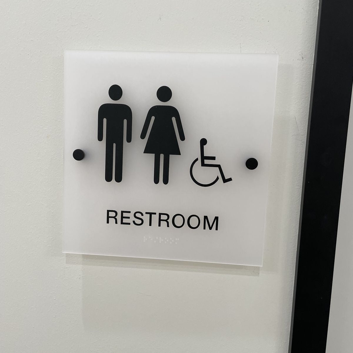 Acrylic restroom sign with men women and wheelchair icon with braille
