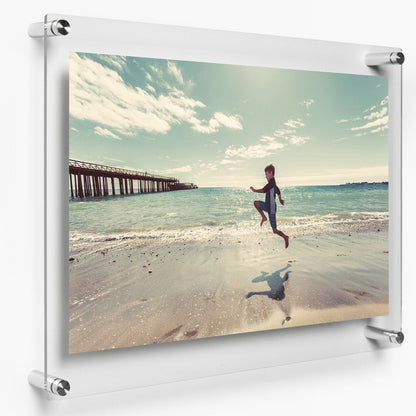 Acrylic photo frame with standoff mount and frameless glass look for wall display.