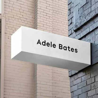 Custom 3D projecting name sign board mounted on wall for business storefront branding.