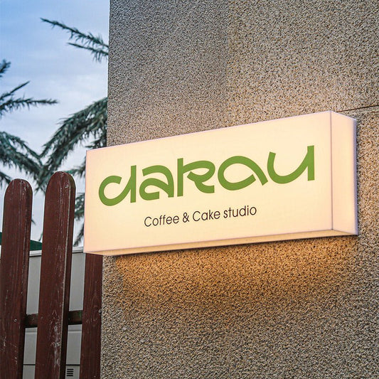 Custom cafe wall light box sign with LED coffee cake studio branding.