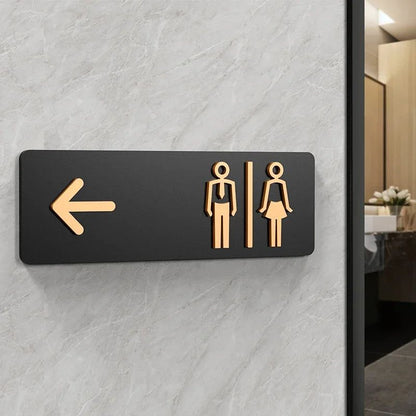 Modern directional restroom sign with left arrow and male female washroom symbols for bathroom wayfinding.