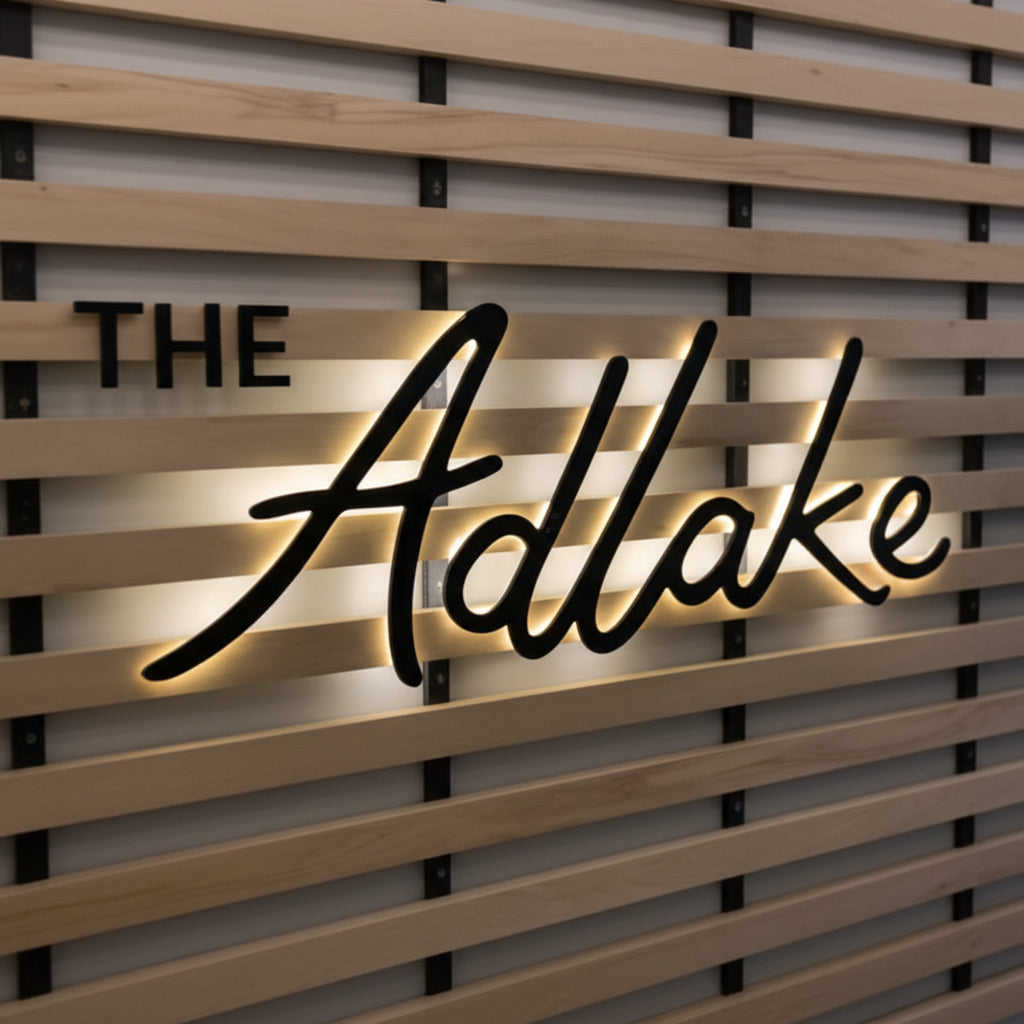 elegant cursive backlit LED sign warm glow wall decor retail branding aesthetic lighting
