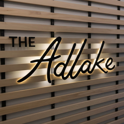 elegant cursive backlit LED sign warm glow wall decor retail branding aesthetic lighting