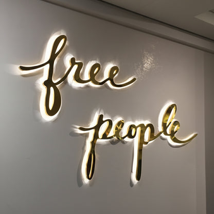 free people style LED script sign warm white backlit cursive wall signage boutique interior