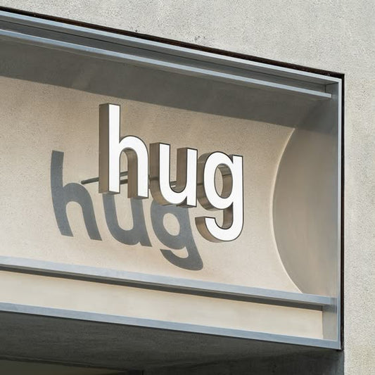 hug 3D acrylic letter sign outdoor non illuminated storefront signage shadow effect branding
