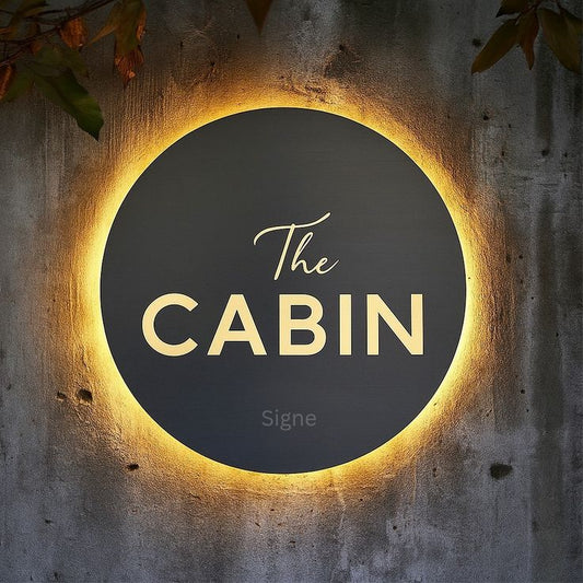 LED circular black acrylic logo sign with gold halo backlit round wall signage for cafe and cabin branding