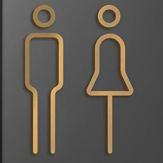 Luxury gold restroom symbols on dark wall
