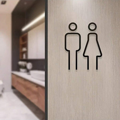 Minimal black male female restroom sign mounted on door
