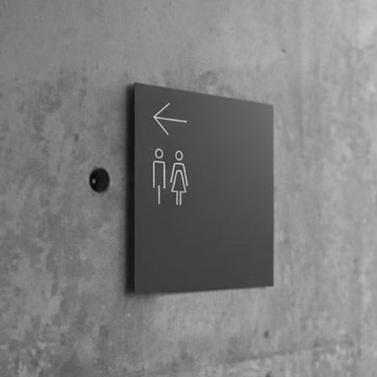 Minimalist directional restroom sign with arrow and washroom symbols for bathroom wayfinding.