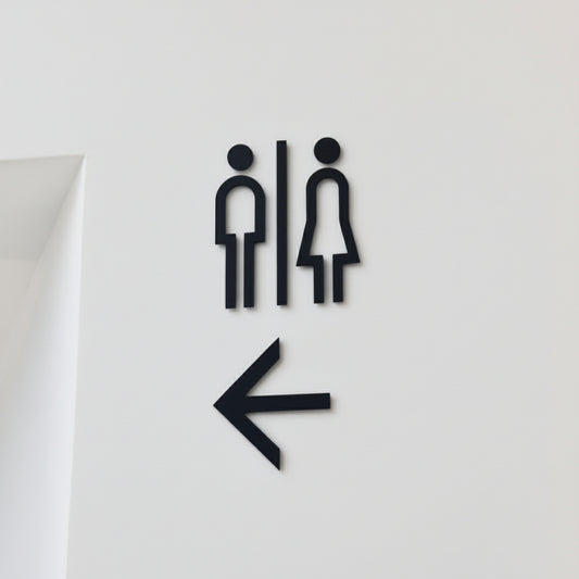 Minimalist restroom wall sign with left arrow
