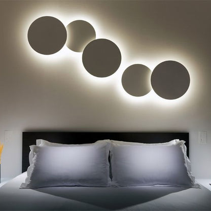Modern LED wall light panel set with circular backlit design for bedroom decor.