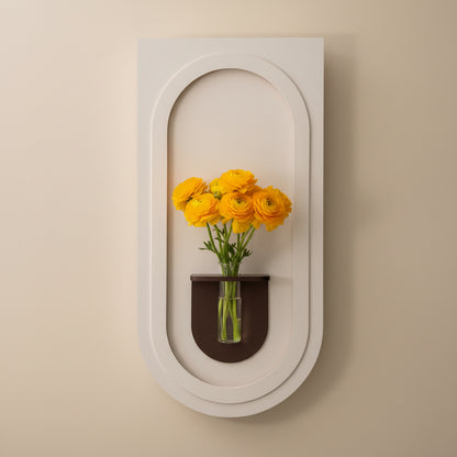 modern minimalist arch wall panel with glass vase and yellow flowers
